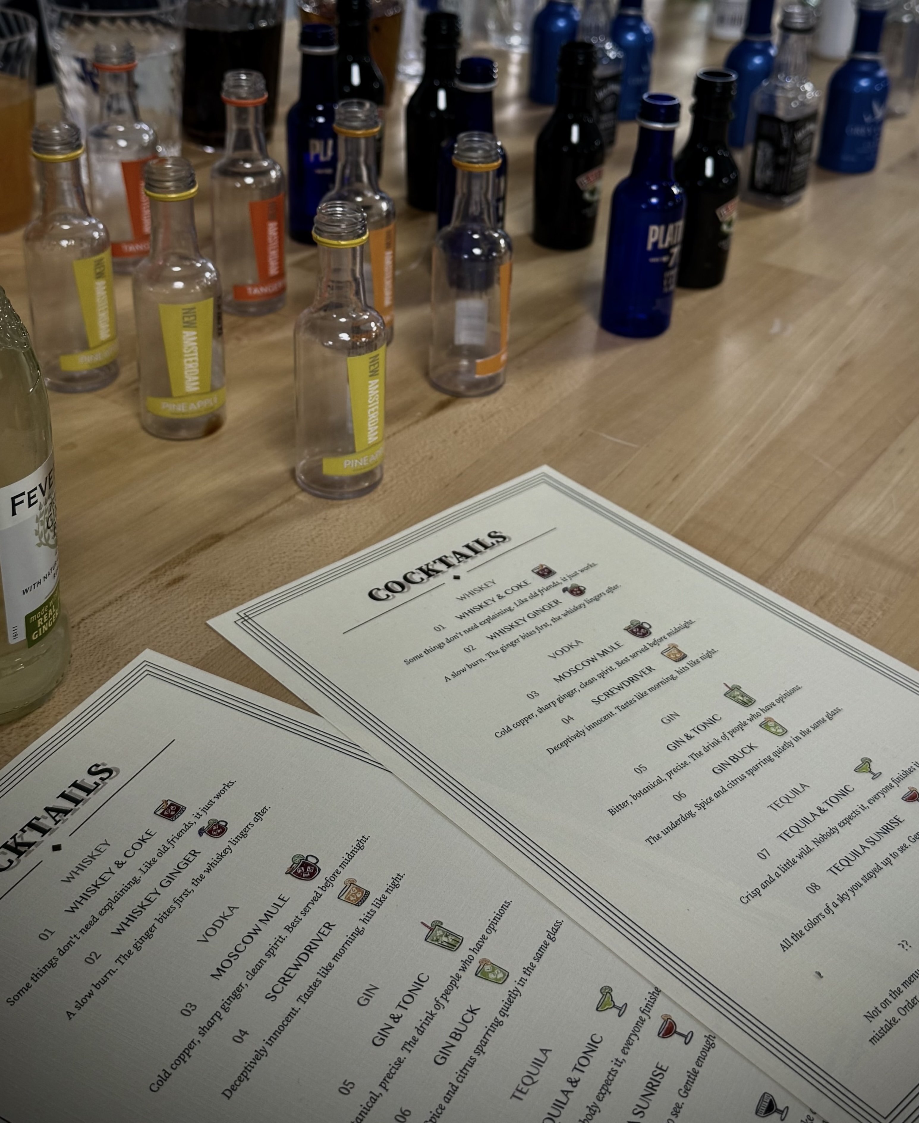 Drunky bar setup — mini bottles and printed cocktail menus